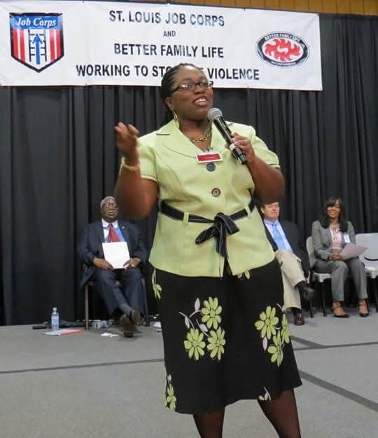 Sophia Downs speaking with a microphone at a Saint Louis Job Corps forum