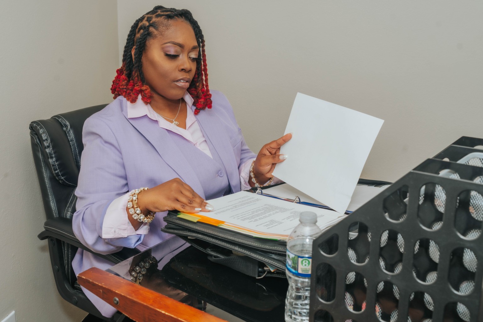 Sophia Downs reviewing program documents at her desk